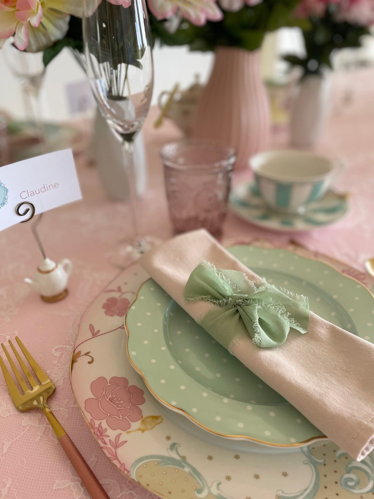 Place setting with floral china, sage napkin ribbon and gold cutlery