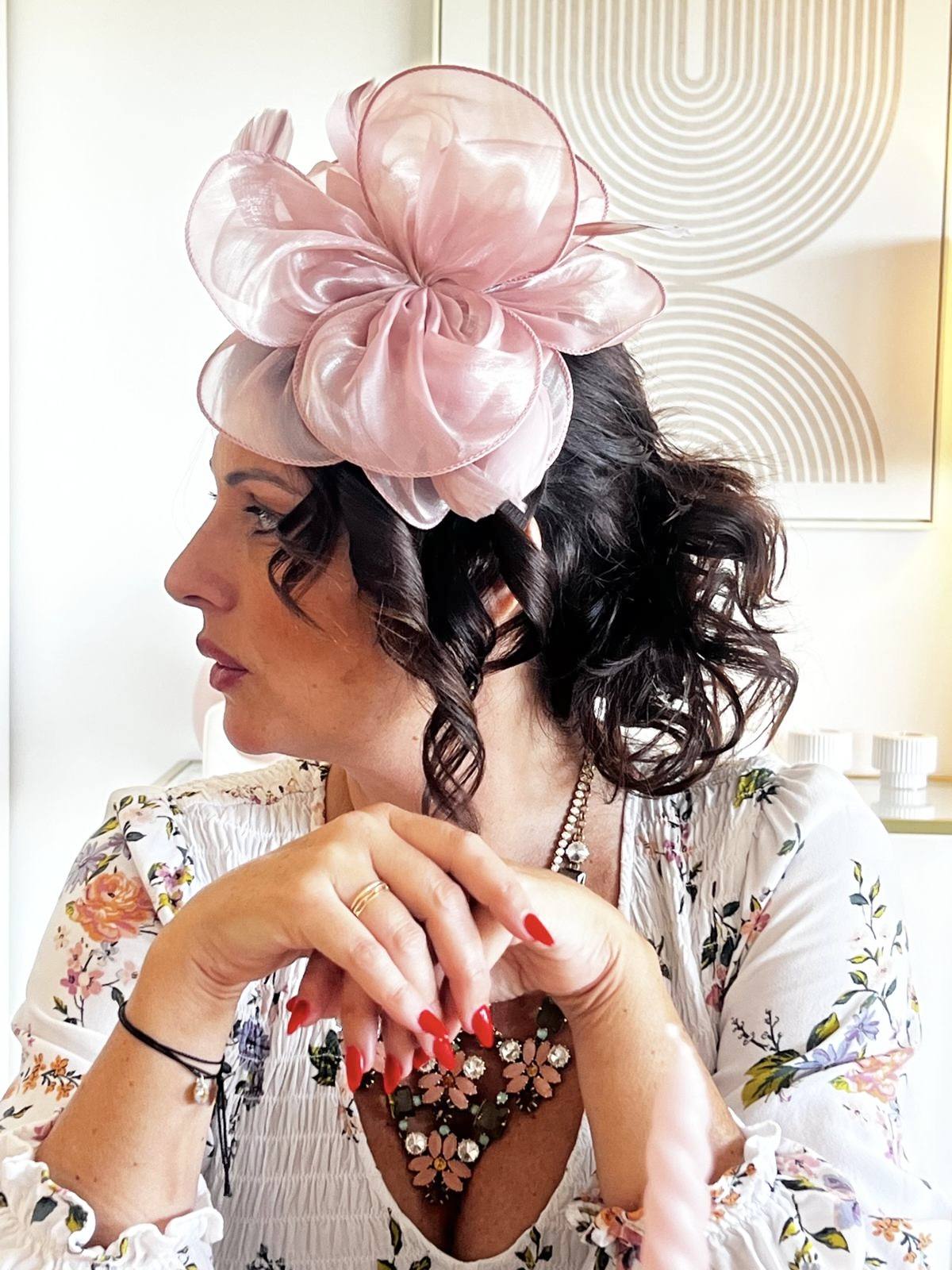 A guest in a pink fascinator at an elegant afternoon tea