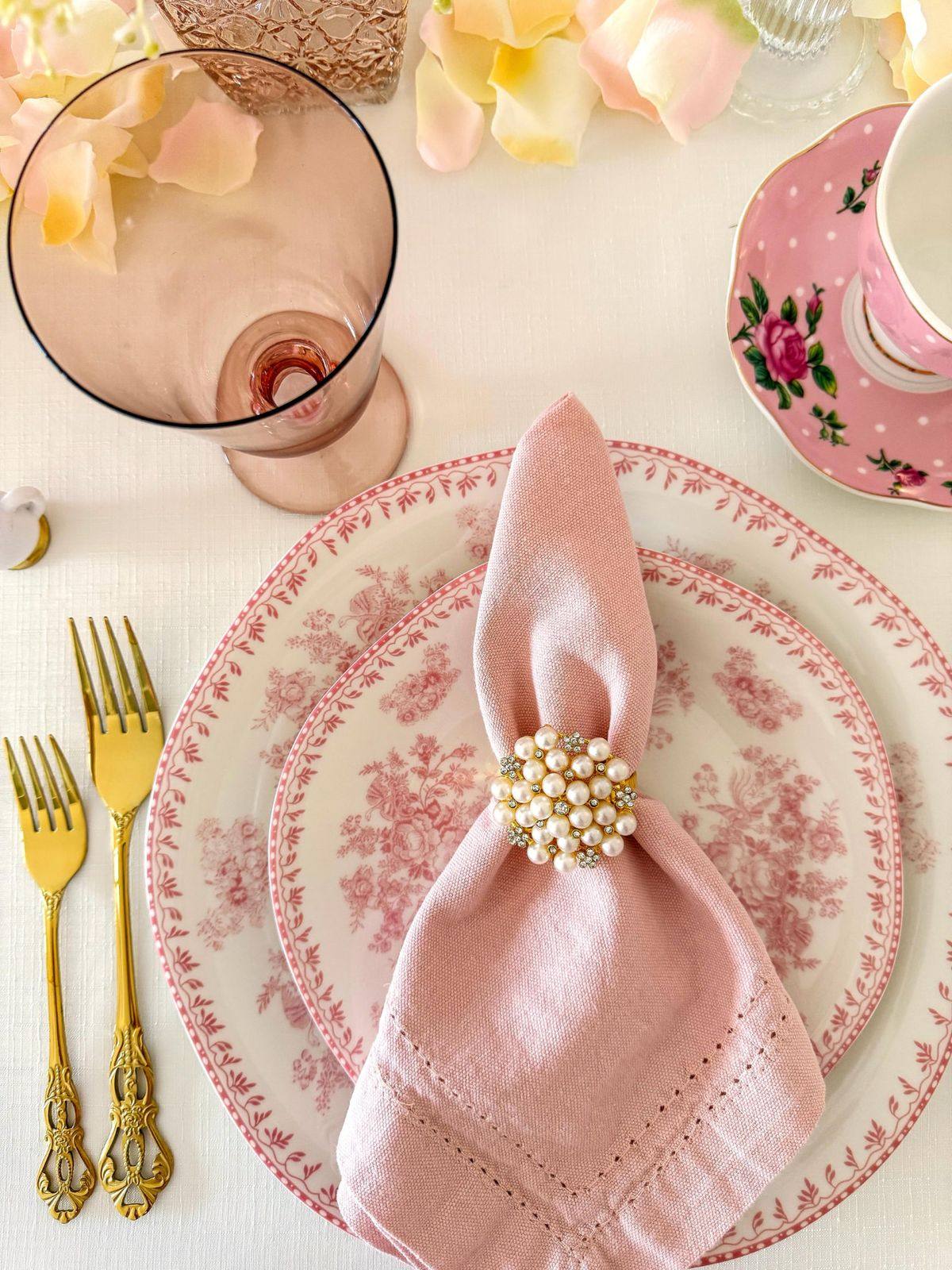 A detailed place setting with fine bone china and gold cutlery
